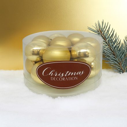 Aranyszínű üveg karácsonyi gömb szett hengeres csomagolásban havas háttérrel (16×3 cm).