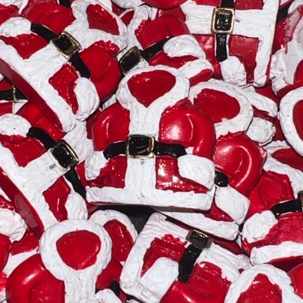 Piros-fehér mikulás kabát formájú öntapadós díszek, fehér háttéren, egy darab hátoldala látható.