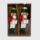 Dobozba csomagolt diótörő katona díszek, átlátszó előlap mögött, arany akasztóval.